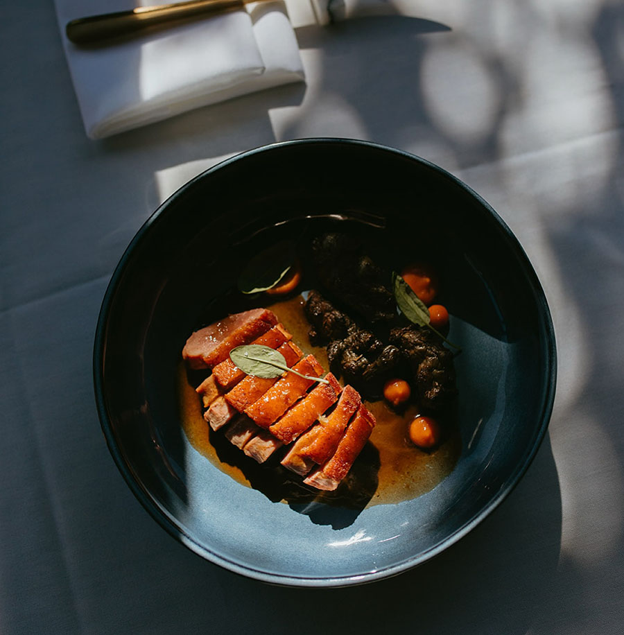 Sliced duck breast, plated.