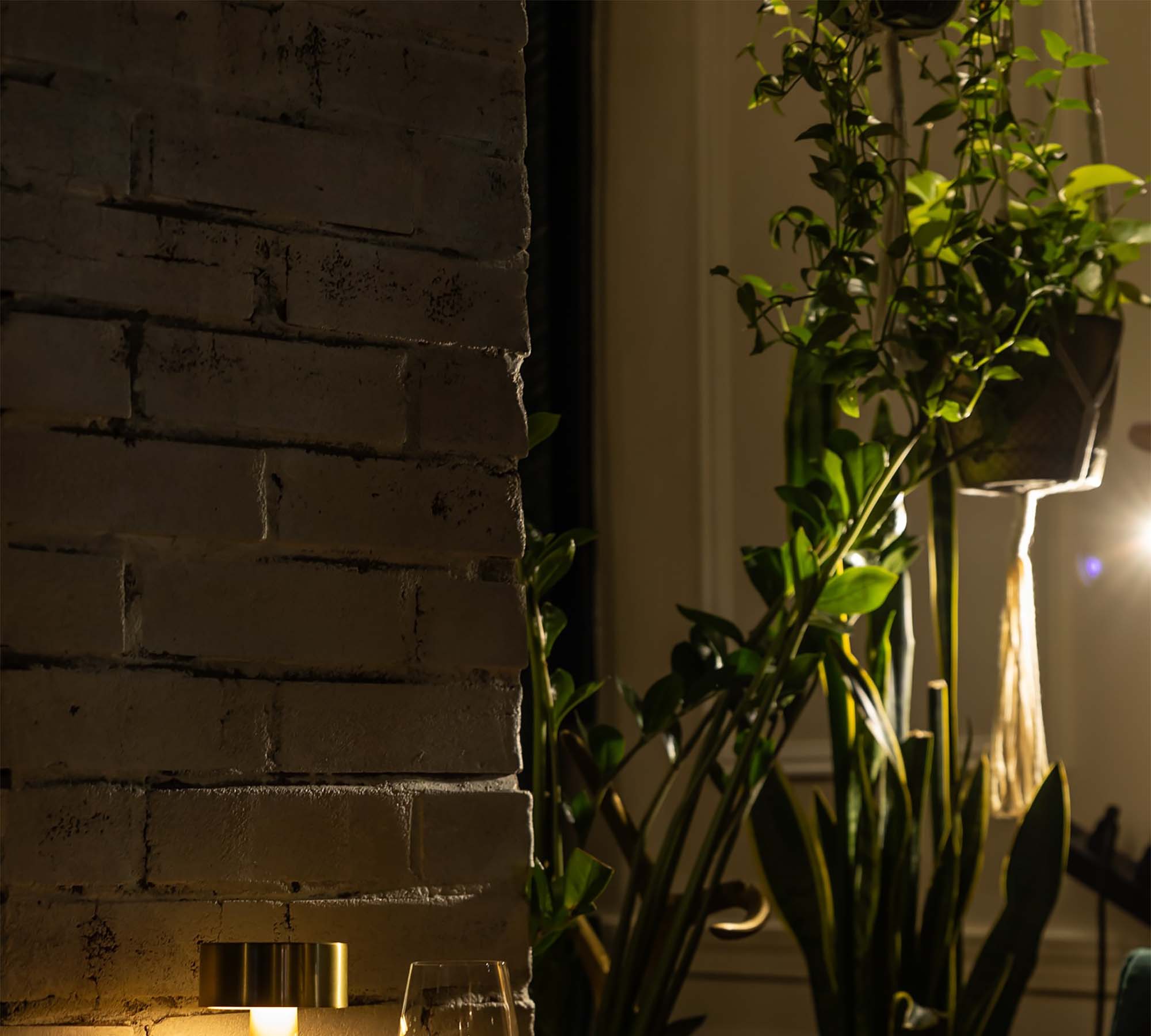 Brass lamp and wine glass at a table setting